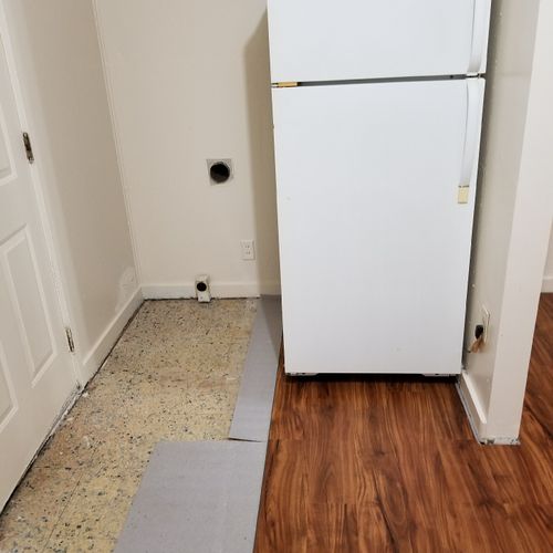 Vinyl flooring behind washer dryer