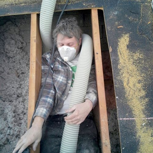 Owner Bob Blowing Attic From Roof