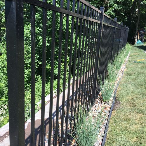 Remove sod, Install Iron fence, edging, rock and p