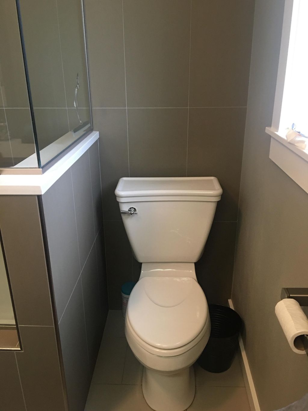 Tiled behind the toilet