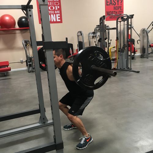 Working with client on proper squat form.