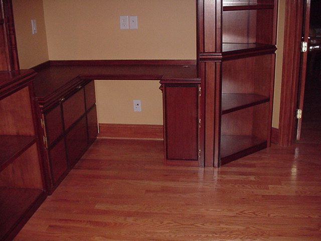Corner desk sports 3 cubbies directly underneath t