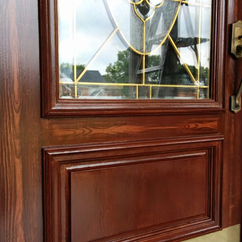 Wood-grained door that was damaged and repaired.