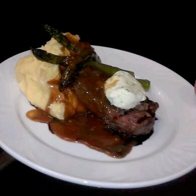 Grilled petite steak set atop garlic chive mashed 
