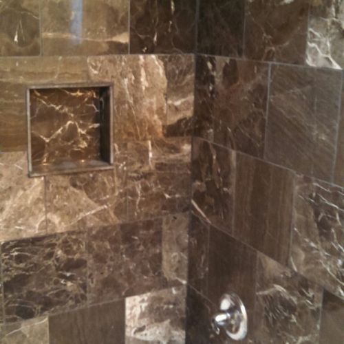 Tiled marble shower with built in niche