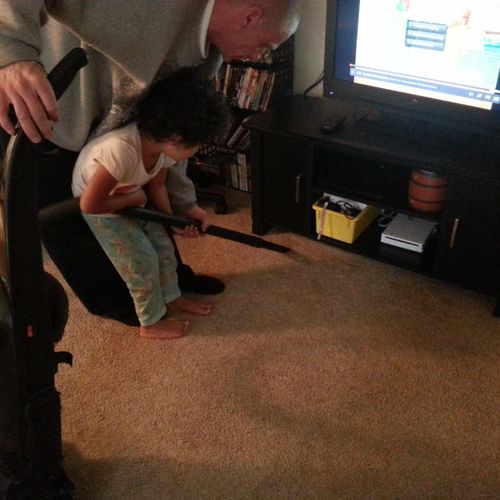 Her first time vacuuming, learning from the best