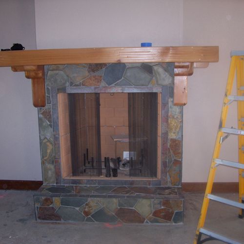 Custom mosaic fireplace surround made of slate