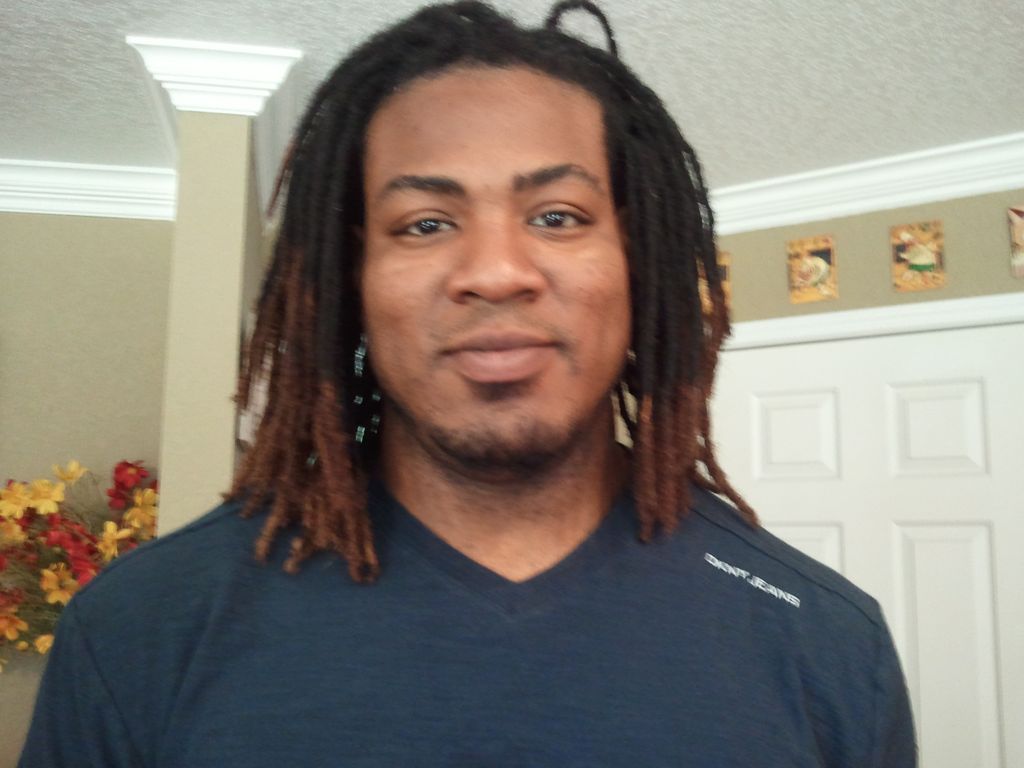 Joshua after just stitching and coloring his dread