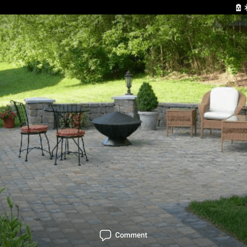 Backyard paver patio with retaining wall and colum
