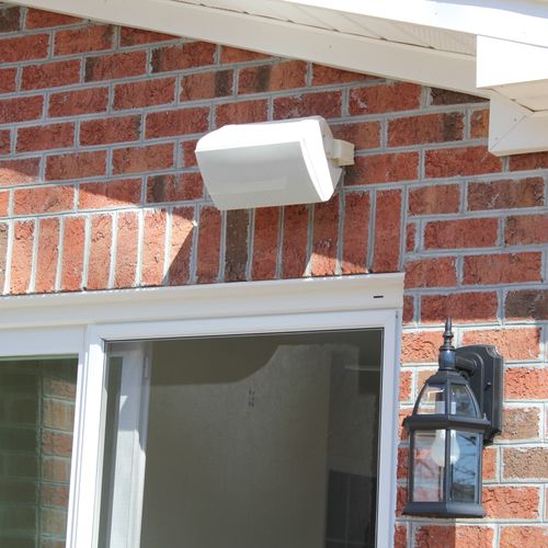 Outdoor bracket speaker installed on porch.