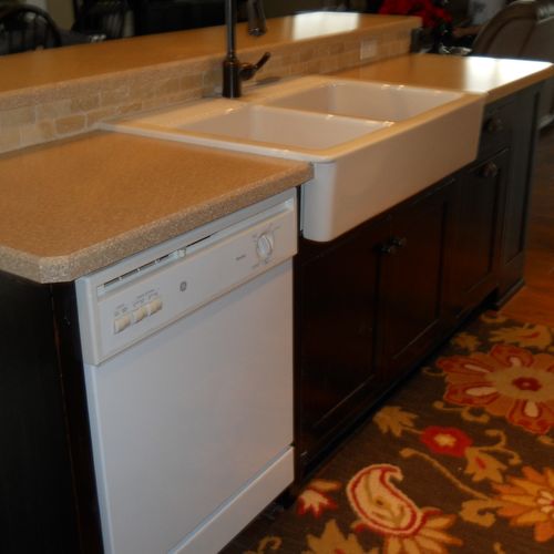 Custom cabinets with farmhouse sink and solid surf