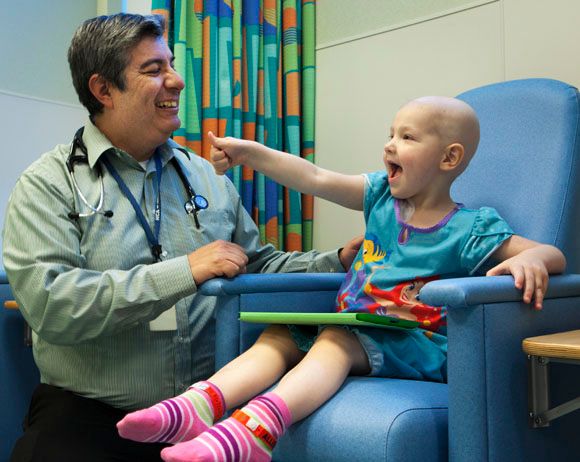 Pediatric oncologist with patient