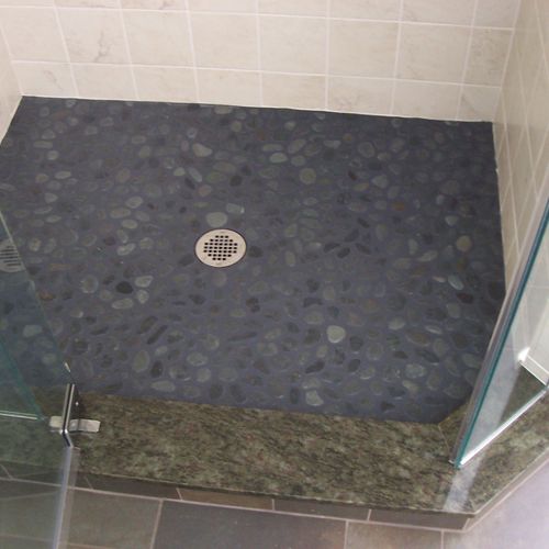 Greenfield Custom tile shower with river stone flo