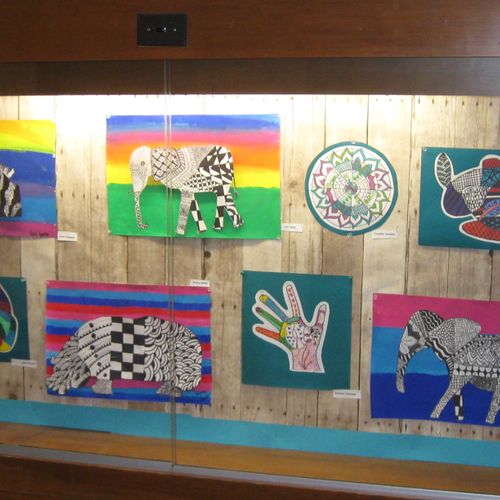 Student completed art work in school display case.
