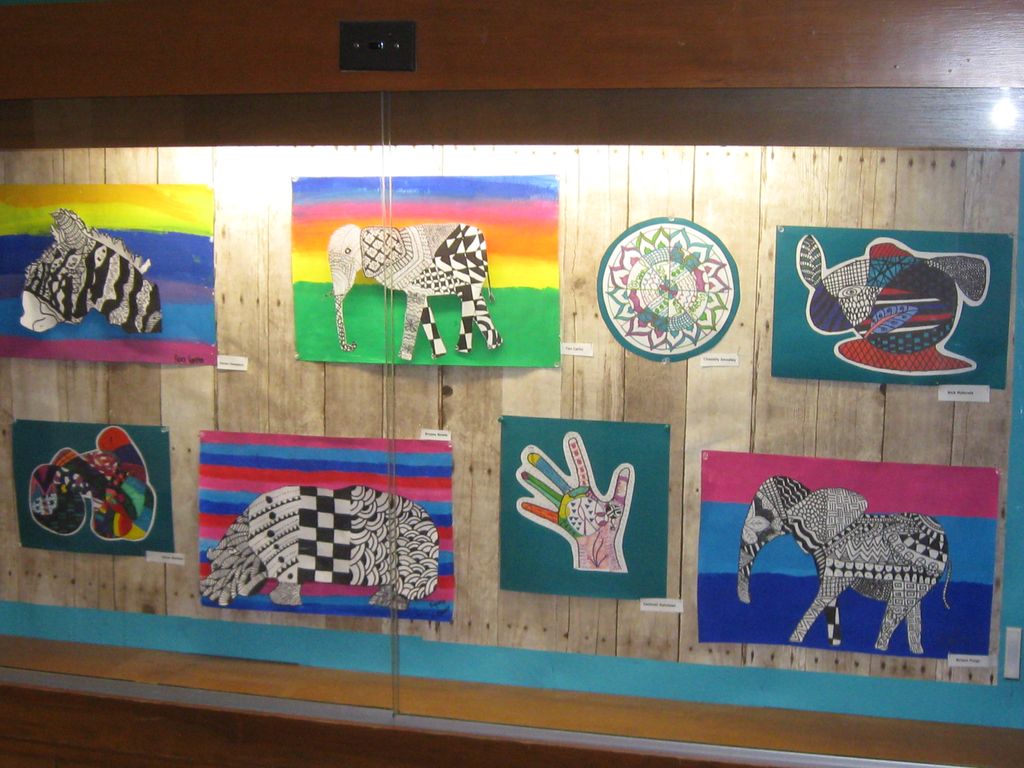 Student completed art work in school display case.
