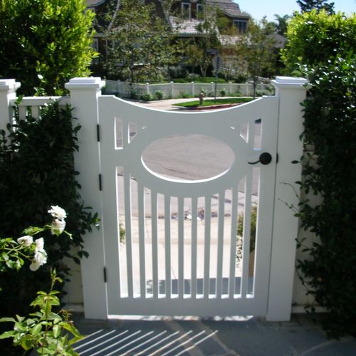 Handmade painted redwood entry gate with oval deta