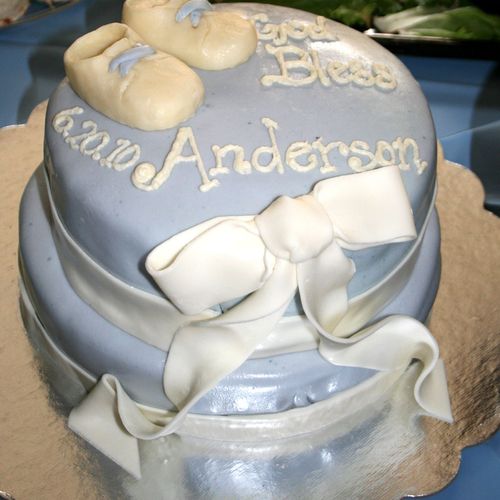 Two-tier fondant-covered baptism cake featuring wh