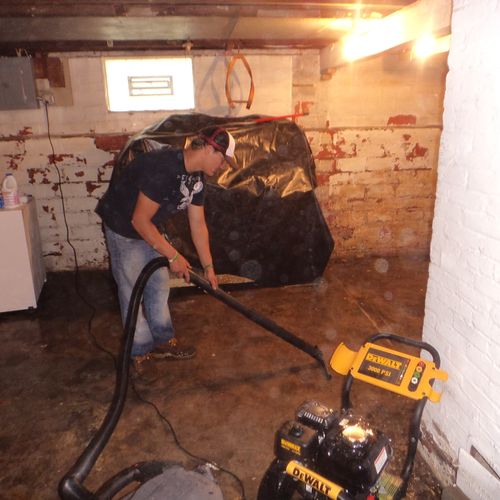Cleaning flooded unfinished basement.