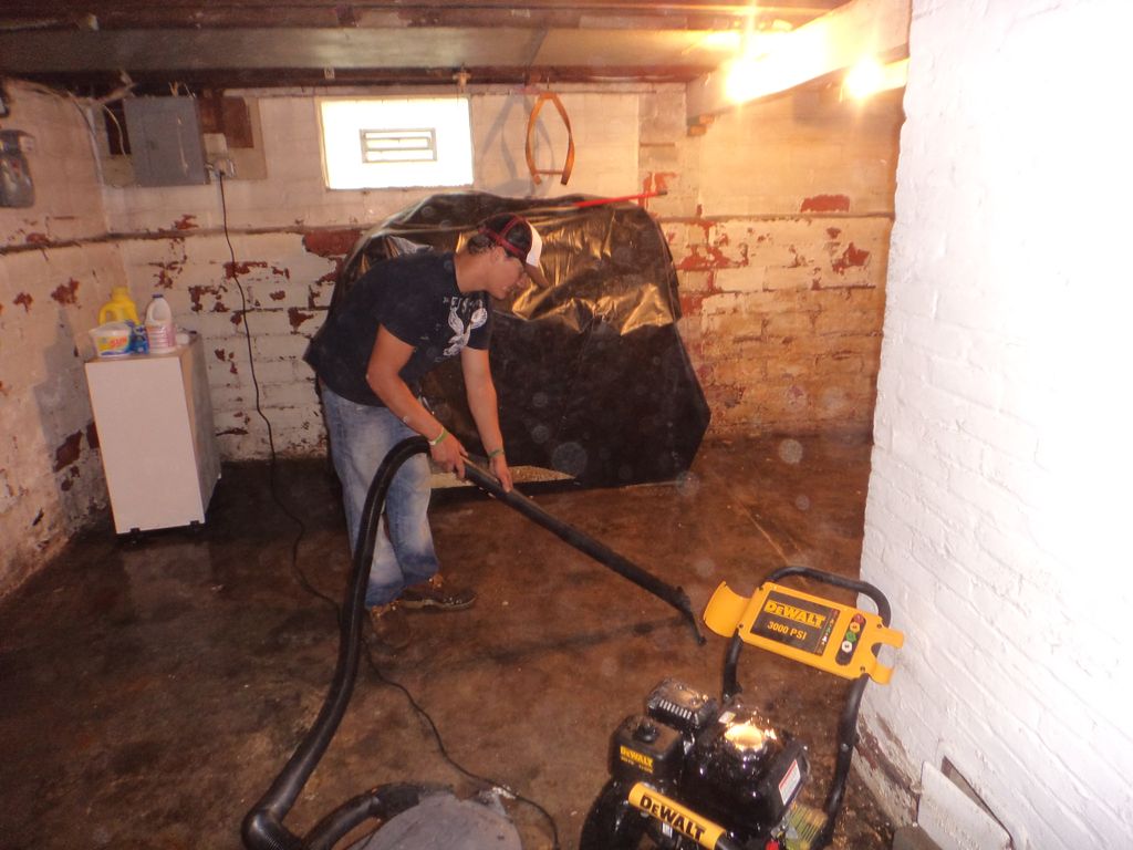 Cleaning flooded unfinished basement.