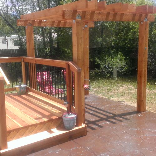 Redwood deck with pergola and stamped concrete