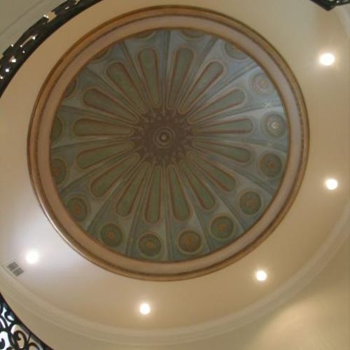 Looking up into a painted dome from the entry of a