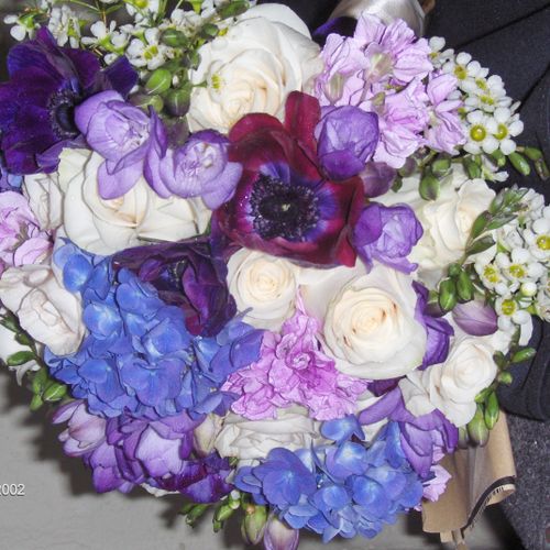 Beautiful bouquet using blues, purples and Ivories