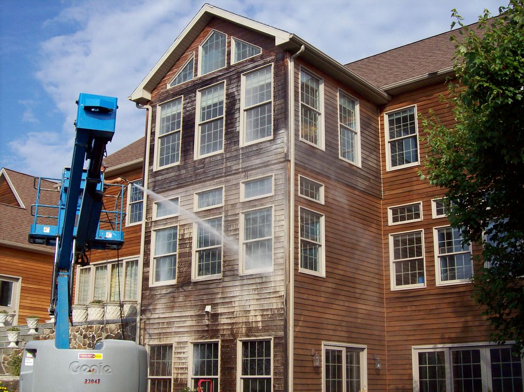 Applying soap to a cedar house.