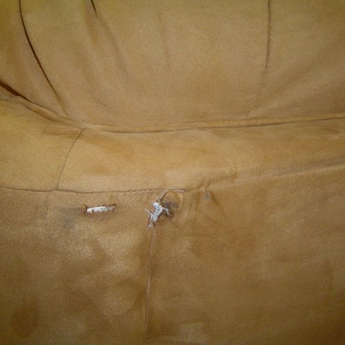 Damaged upholstery during delivery on back of sofa
