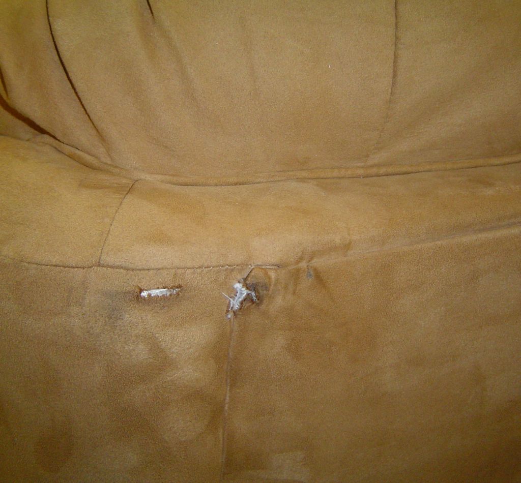 Damaged upholstery during delivery on back of sofa