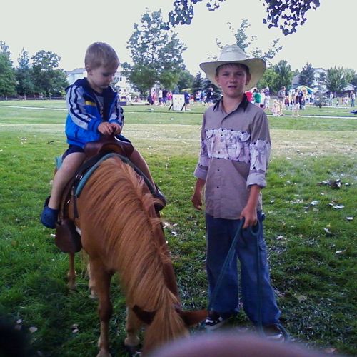 Our cowboy walking the pony and his rider