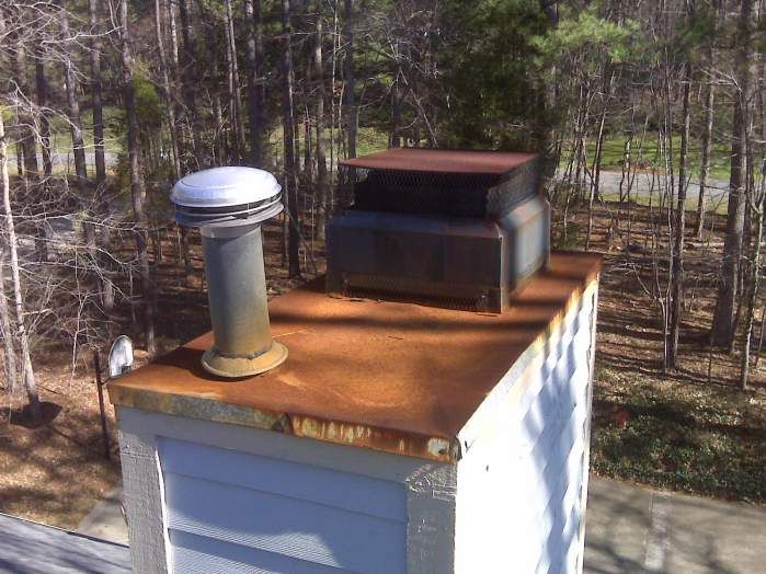 Rusted chimney top before replacement