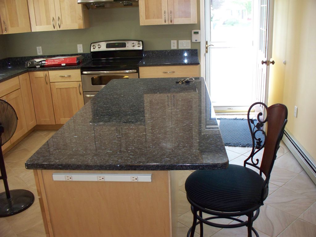 Maple cabinets with green quarts stone counter top