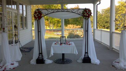 Black iron scroll arch.  Wedding colors red, black