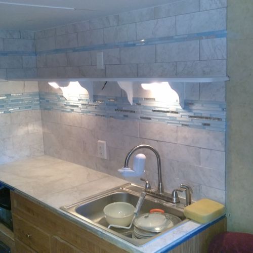 small tile job with custom blue grout in glass til