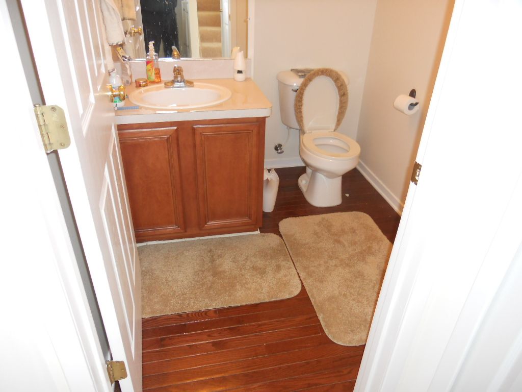 Before.  small powder room at end of short hall wi