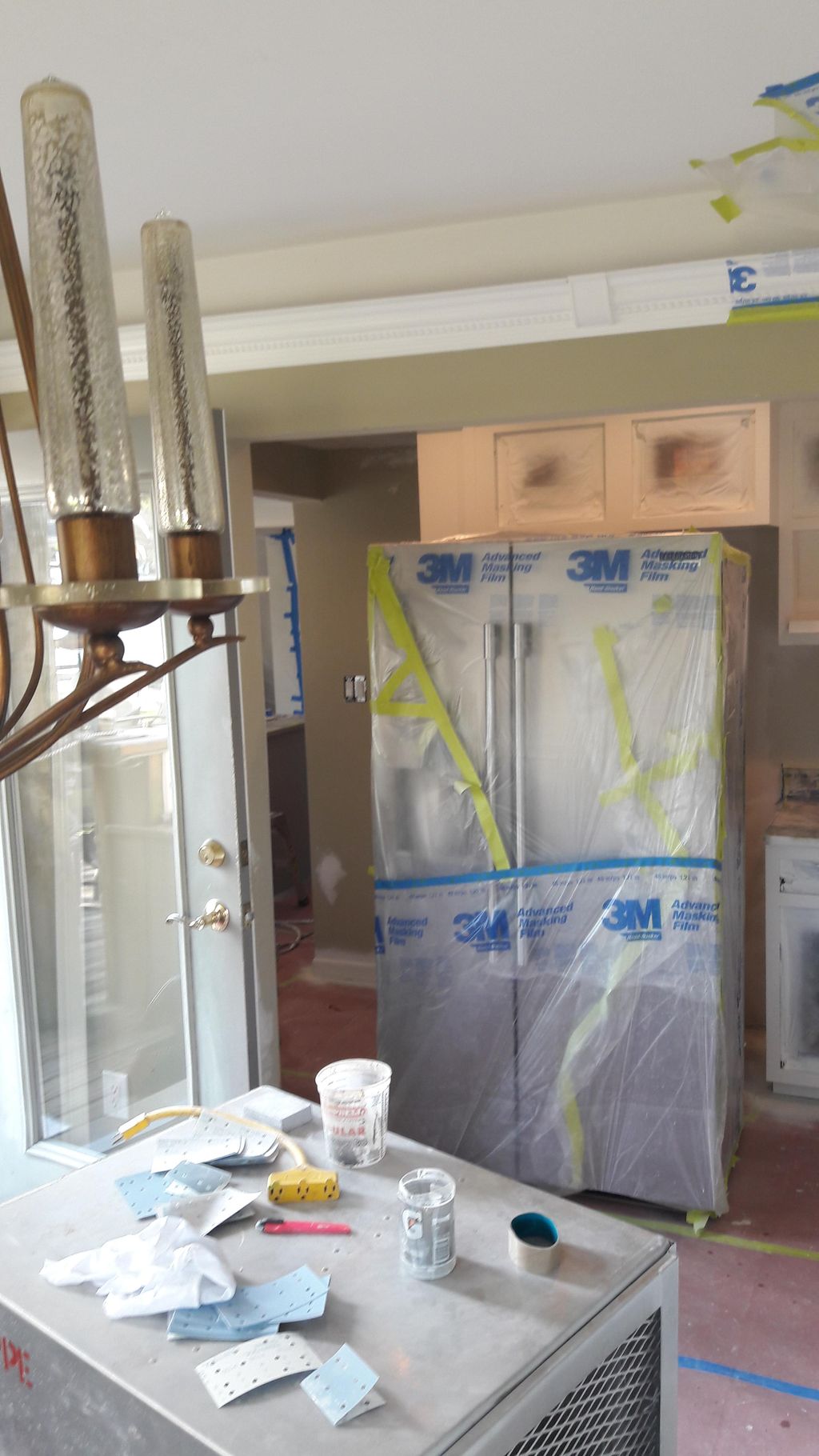 covering all of the appliances with plastic