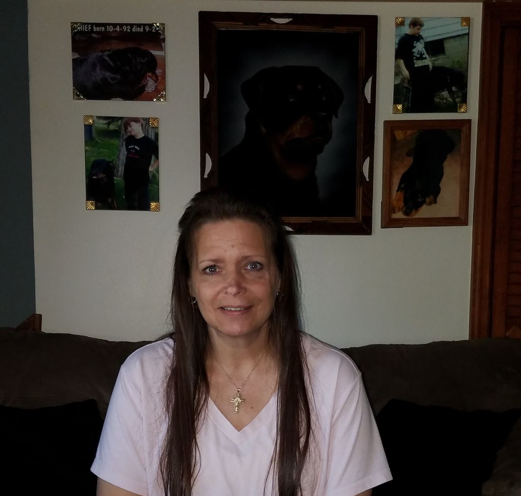 In the photos behind me are my sons.  My dog liste