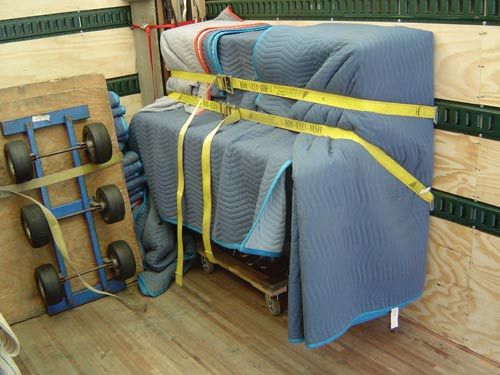 Piano safely padded and strapped.