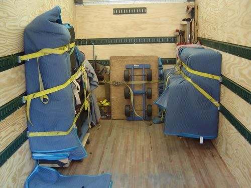 Piano safely padded and strapped.