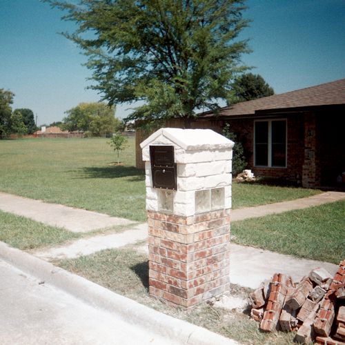Brick and stone  mailbox with glass block accents.