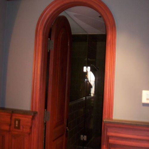 Custom arched door jamb with solid wood door