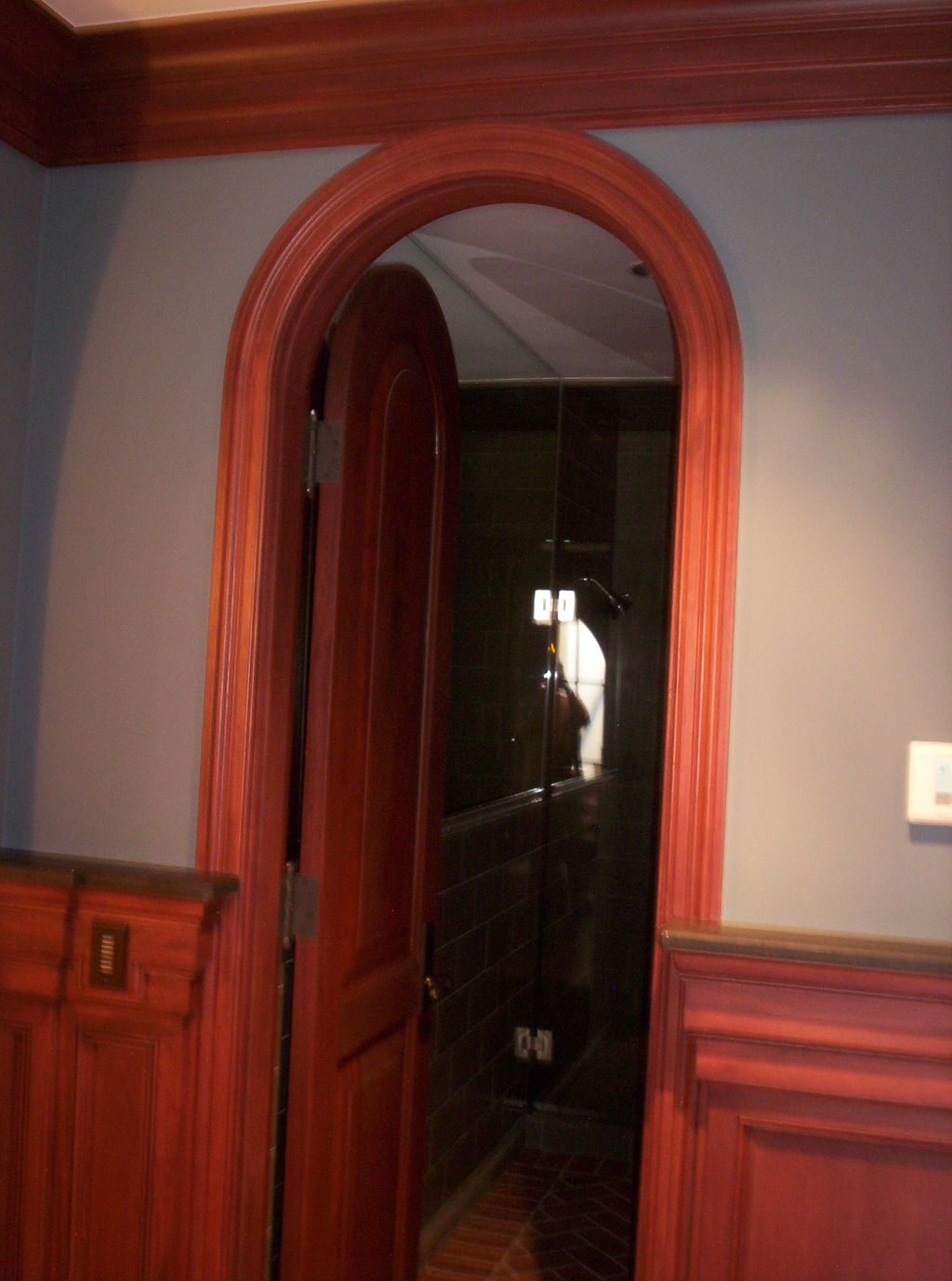 Custom arched door jamb with solid wood door