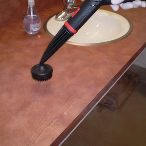 Steam cleaning a bathroom counter top