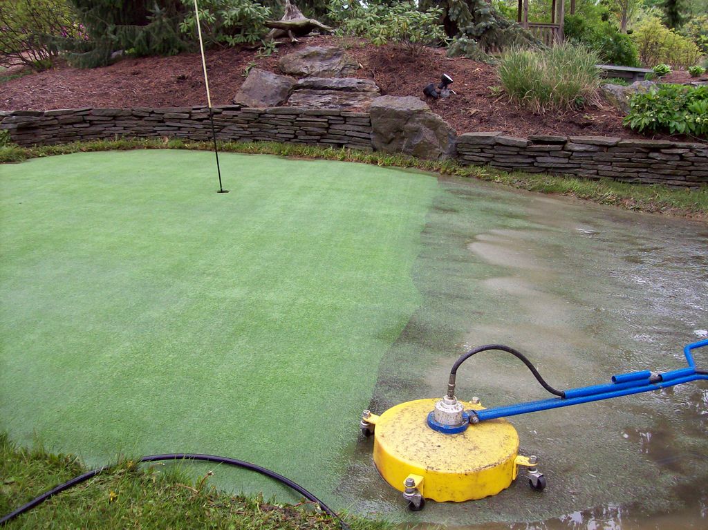 Artificial golf green IN PROCESS of being cleaned.