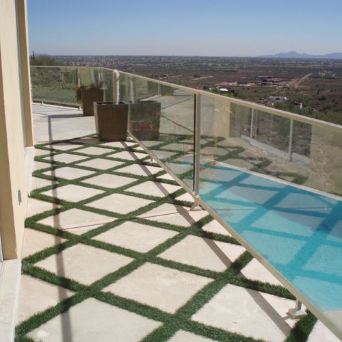 Artificial grass and travertine tiles for a second