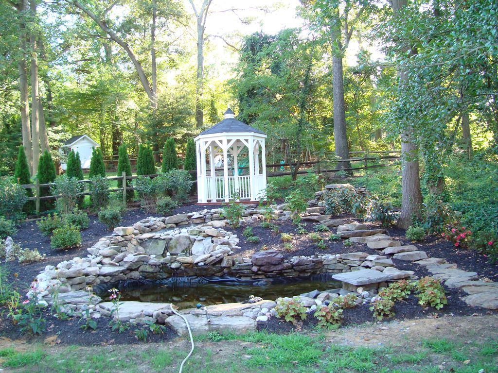 WATERFALL, BROOK, & KOI PONDS. WE INSTALLED THE GA