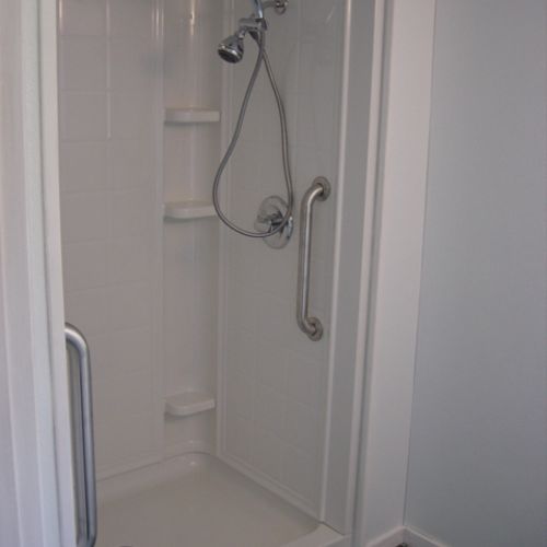 Accessible shower with grab bars and handle held s