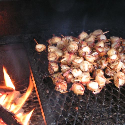 Bacon wrapped scallops over wood fired grill