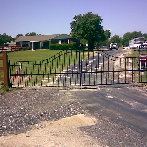 A small 20 by 5 foot wrought gate for a horse farm