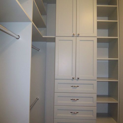 Painted closet system with doors and crown molding